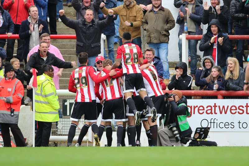 Redemption: Hogan and his team-mates celebrate his last-gasp leveller against Bristol City (photo by Pro Sport Images)