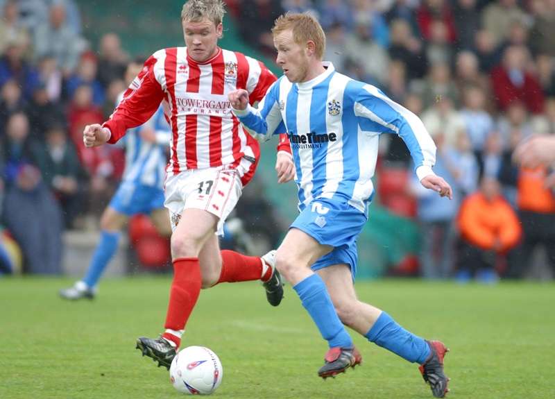Defensive duties: McCann in action for Cheltenham against Huddersfield Town (photo by Action Images / Gareth Bumstead)