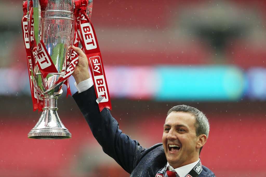 Serious competition: Fleetwood Town chairman Andy Pilley holds aloft the League Two play-off final trophy in 2014 (Photo by Action Images)