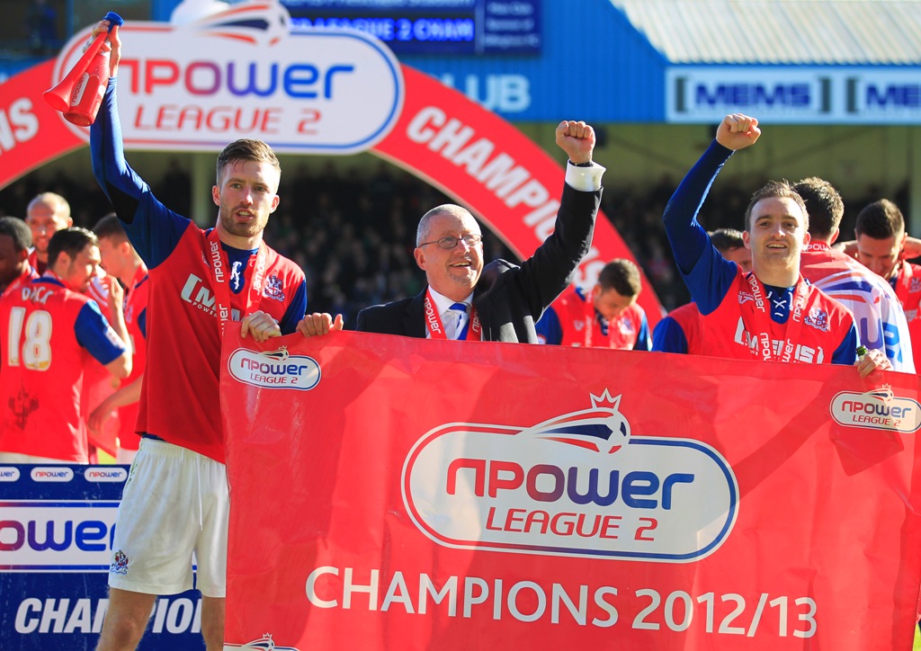 Gillingham chairman Paul Scally (middle) celebrates the club winning League Two. (Picture: Action Images)