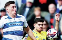 PHYSICAL: QPR defender Jimmy Dunne, left, challenges Leeds’ Manor Solomon PICTURE: Alamy