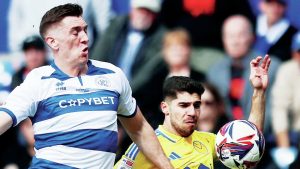 PHYSICAL: QPR defender Jimmy Dunne, left, challenges Leeds’ Manor Solomon PICTURE: Alamy