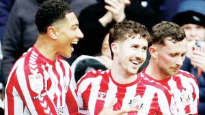 ALL-SMILES: Sunderland’s Trai Hume, centre, celebrates his winner with Jobe Bellingham, left PICTURES: Alamy