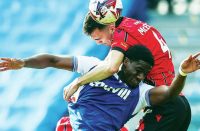 UP FOR IT: Gillingham’s Joseph Gbode and Walsall’s Oisin McEntee clash PICTURES: Alamy