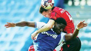 UP FOR IT: Gillingham’s Joseph Gbode and Walsall’s Oisin McEntee clash PICTURES: Alamy