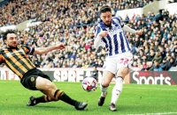 ON THE STRETCH: Hull’s Lewie Coyle attempts to block the cross of West Brom’s Mikey Johnston PICTURES: Alamy