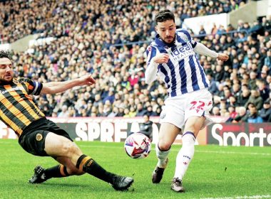 ON THE STRETCH: Hull’s Lewie Coyle attempts to block the cross of West Brom’s Mikey Johnston PICTURES: Alamy