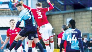 CHALLENGE: Wrexham’s Lewis Brunt and Wycome’s Caleb Taylor battle for the ball PICTURES: PRiME Media Images