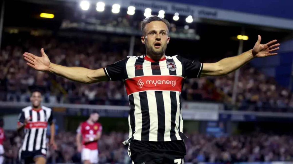 Charles Vernam celebrates his opener for Grimsby (Nigel French/PA)