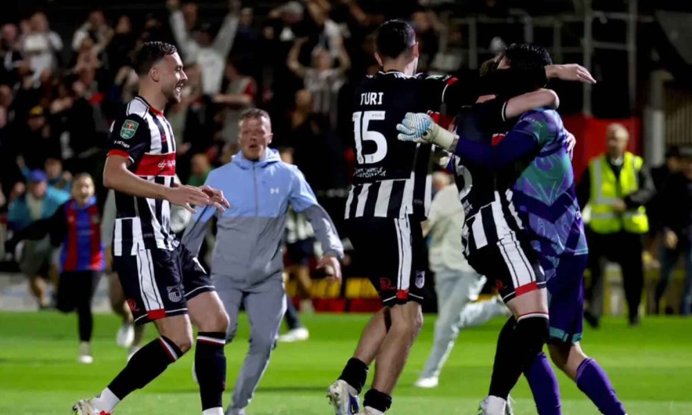 Grimsby goalkeeper Christy Pym (right) is congratulated by his team-mates (Nigel French/PA)