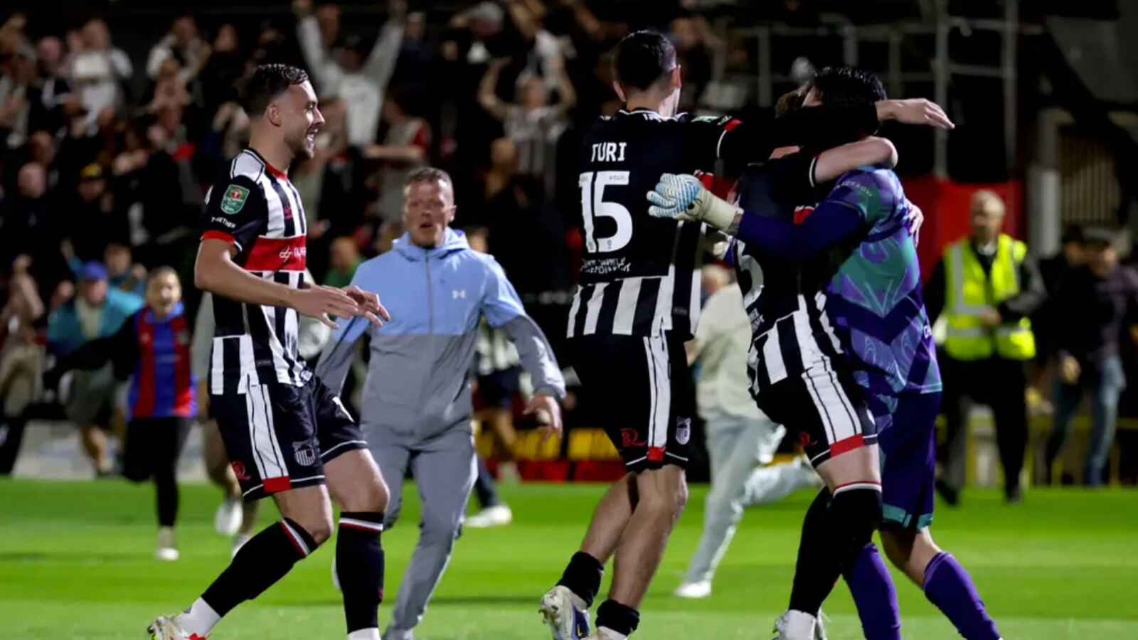 Grimsby goalkeeper Christy Pym (right) is congratulated by his team-mates (Nigel French/PA)