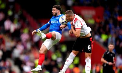 Portsmouth’s Conor Chaplin (left) battle for possession of the ball in the air with Southampton’s Taylor Harwood-Bellis