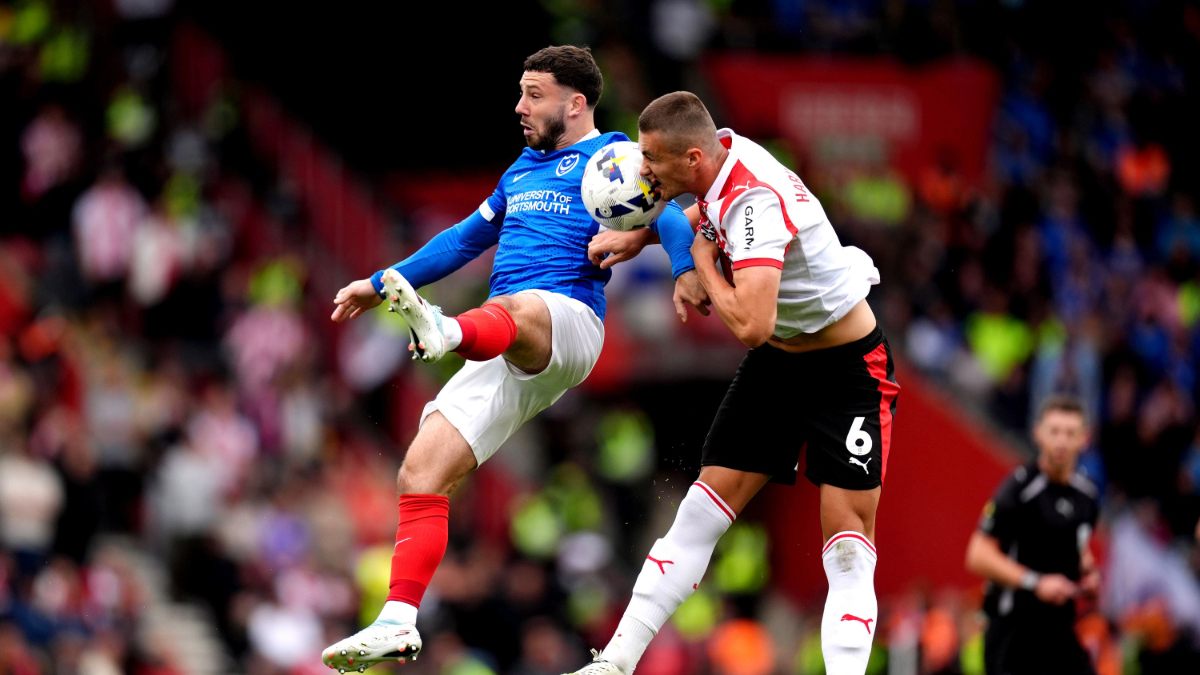 Portsmouth’s Conor Chaplin (left) battle for possession of the ball in the air with Southampton’s Taylor Harwood-Bellis