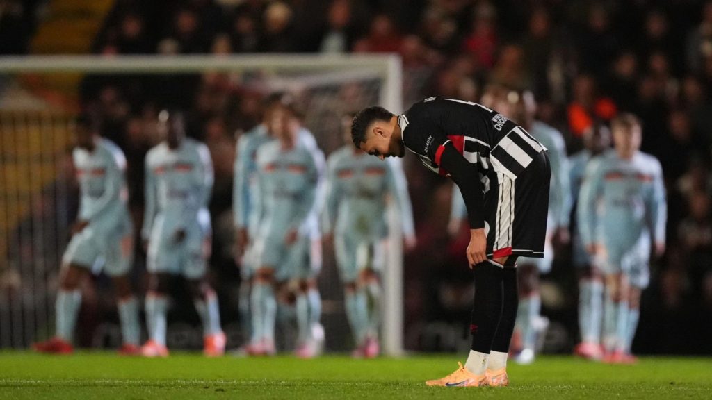 Grimsby Town’s Jaze Kabia adjusts his socks