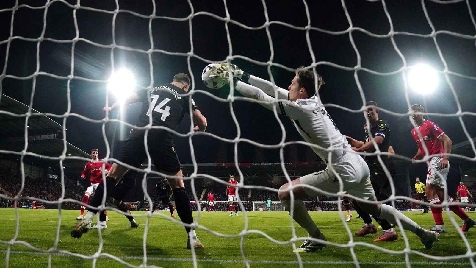 Oxford goalkeeper Jamie Cumming fails to stop Wrexham’s Nathan Broadhead (left) from scoring