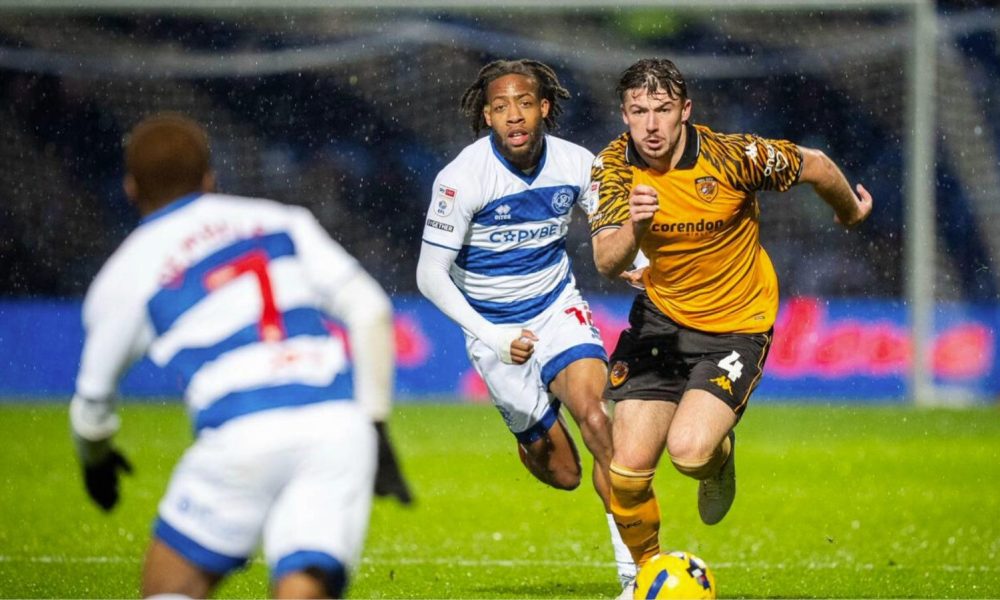 Hull City’s Charlie Hughes, right, attempts to break away from QPR match-winner Rumarn Burrell