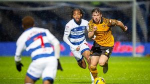 Hull City’s Charlie Hughes, right, attempts to break away from QPR match-winner Rumarn Burrell