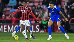 Walsall’s Daniel Kanu is tracked by Bromley’s Omar Sowunmi