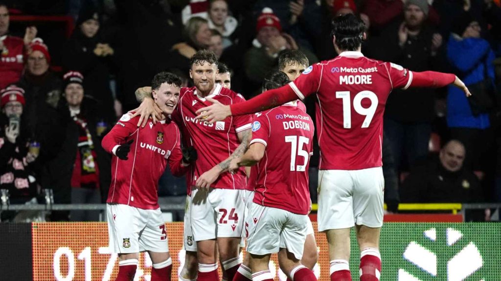 Nathan Broadhead (left) celebrates his goal for Wrexham