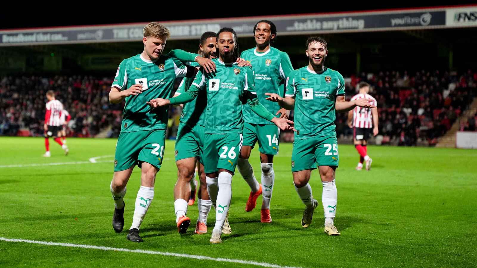 Notts County's Tyrese Hall (centre) celebrates with team-mates