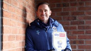Coventry City boss Frank Lampard shows off his prize