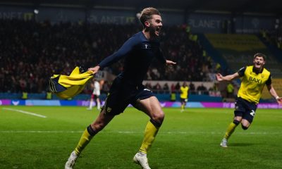 Stan Mills wheels away shirtless after firing home the decisive goal for Oxford United.