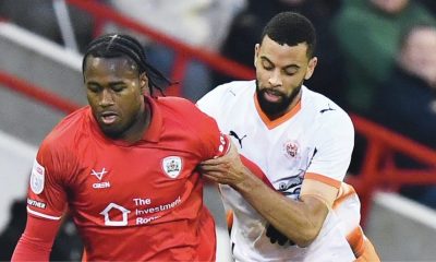 Barnsley’s Reyes Cleary is tracked by Blackpool’s CJ Hamilton