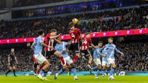 Exeter City’s Ed Turns heads the ball away