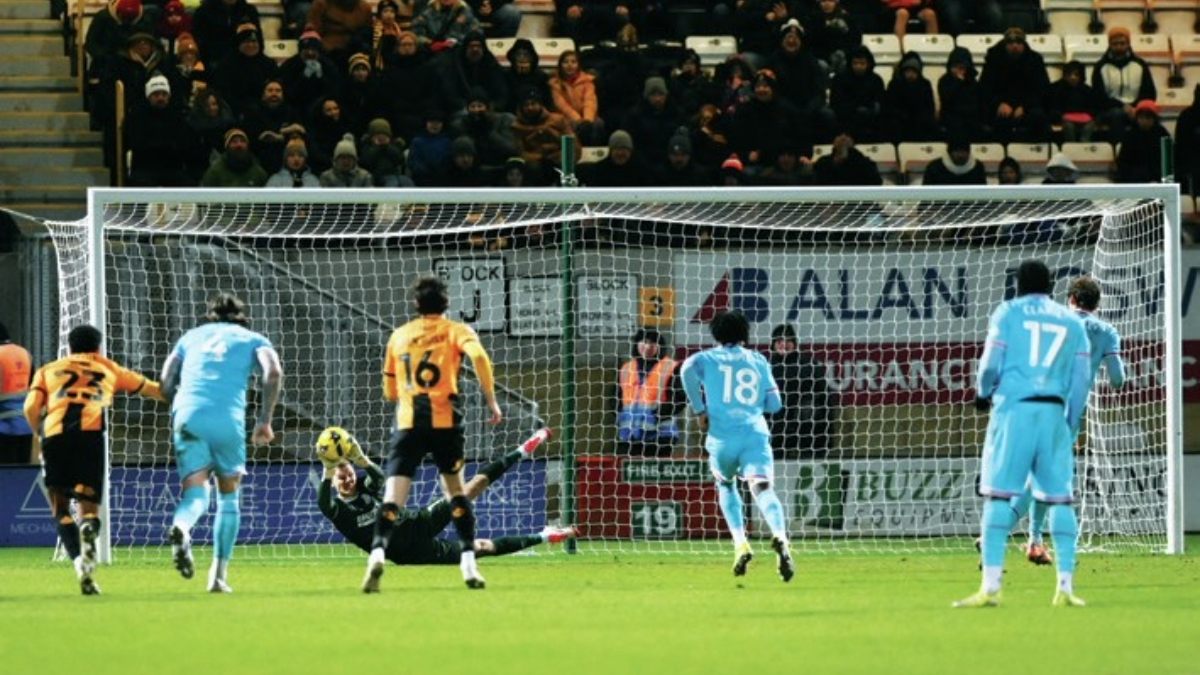 Cambridge United’s keeper Jake Eastwood saves Aaron Pressley’s penalty for Walsall