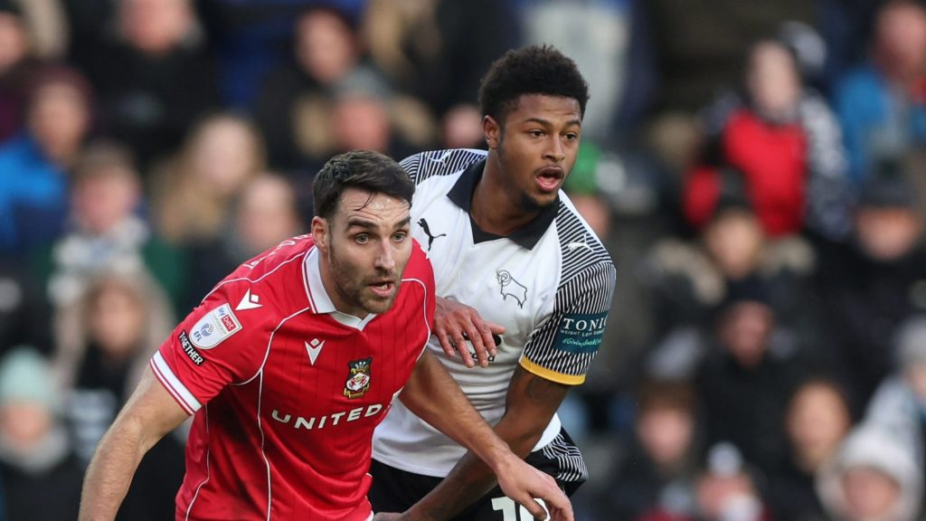 Wrexham’s Matty James (left) and Derby County’s Rhian Brewster battle for the ball