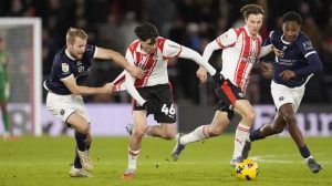 Southampton’s Jay Robinson and Millwall’s Billy Mitchell (left) battle for the ball