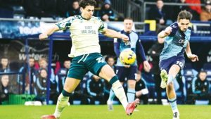 Wycombe Wanderers’ Luke Leahy takes a shot at goal under pressure from Cardiff City forward Yousef Salech