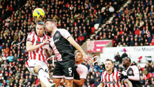 Stoke’s Maksym Talovierov competes with QPR’s Steve Cook