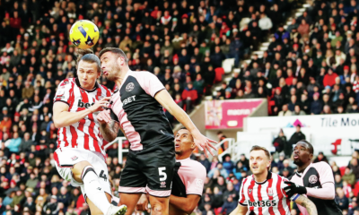 Stoke’s Maksym Talovierov competes with QPR’s Steve Cook