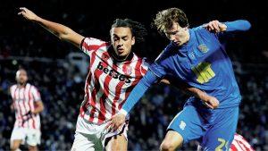 Birmingham City’s August Priske and Stoke City’s Ashley Phillips battle for the ball
