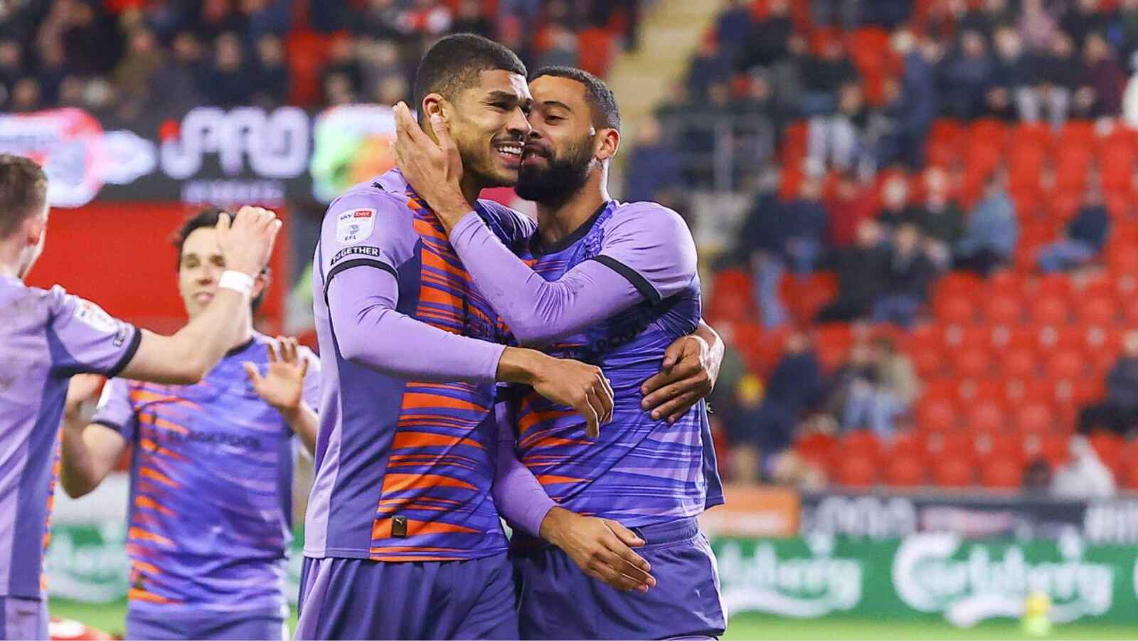 Ashley Fletcher, left, celebrates another goal for Blackpool with CJ Hamilton