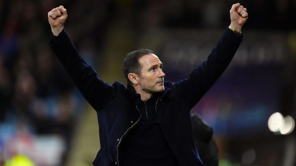 Frank Lampard holds his arms aloft