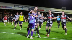 Grimsby Town celebrate knocking Manchester United out of the Carabao Cup