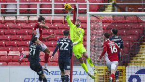 Barrow keeper Wyll Stanway clears the danger