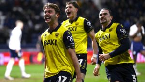 Oxford United celebrate their third goal, scored by Ciaron Brown, right