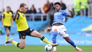 Oxford United’s Jack Currie tackles Derby County’s Rhian Brewster
