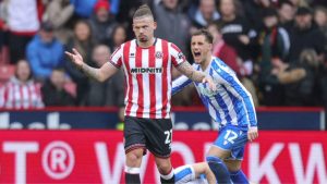 Kalvin Phillips holds his hands up after his foul on Sheffield Wednesd