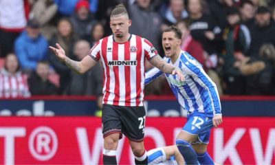 Kalvin Phillips holds his hands up after his foul on Sheffield Wednesd