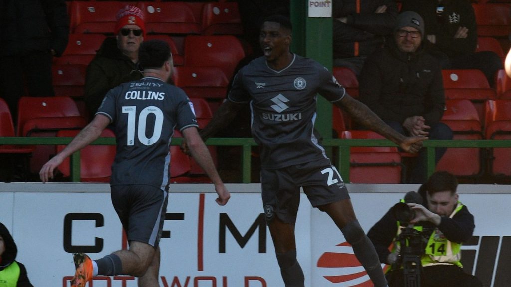 Milton Keynes Dons’ Marvin Ekpiteta celebrates scoring his side’s second with Aaron Collins
