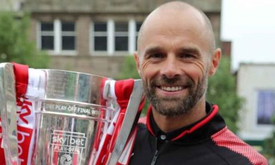 Former Rotherham United manager Paul Warne holds aloft the League One play-off trophy