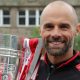 Former Rotherham United manager Paul Warne holds aloft the League One play-off trophy
