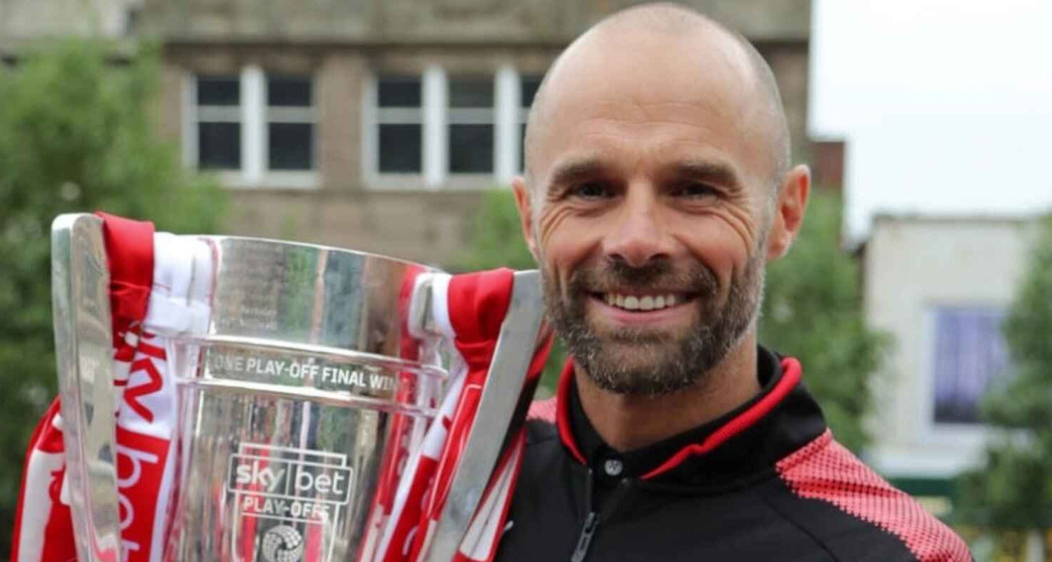 Former Rotherham United manager Paul Warne holds aloft the League One play-off trophy
