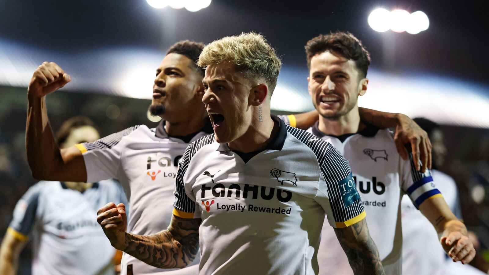 Derby County’s Sam Szmodics (centre) celebrates with team-mates