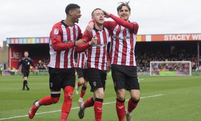 Lincoln City’s Jack Moylan, centre, celebrates scoring with team-mates Reeco Hackett, left, and Tom Bayliss, right.