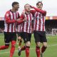 Lincoln City’s Jack Moylan, centre, celebrates scoring with team-mates Reeco Hackett, left, and Tom Bayliss, right.